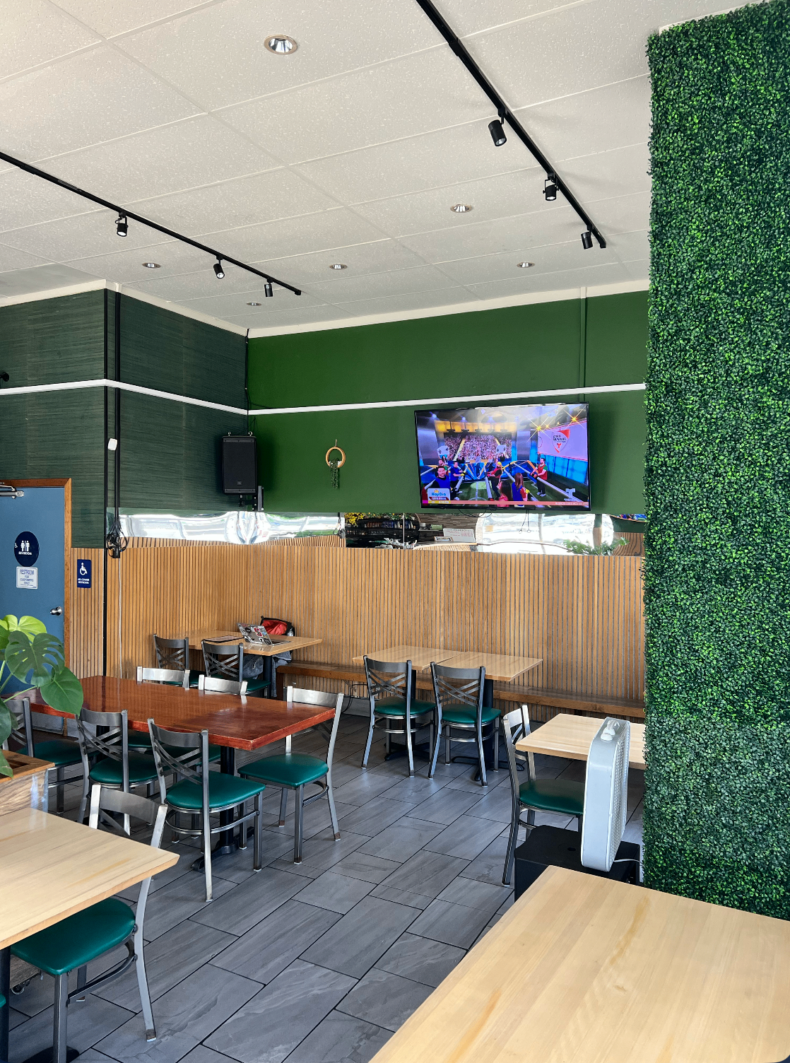 Cozy dining room with green walls and wood paneling