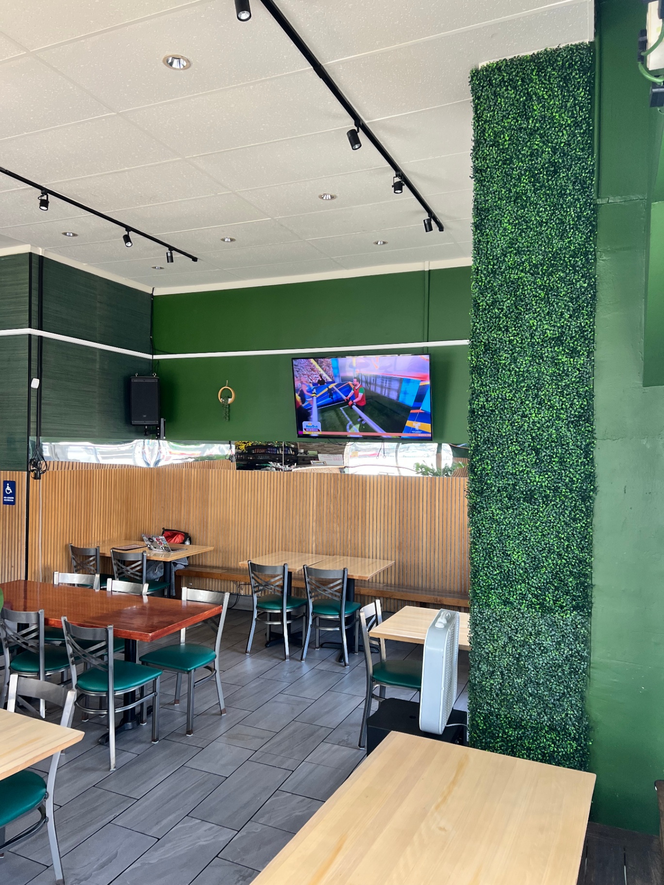 Dining room with green walls and living plant wall
